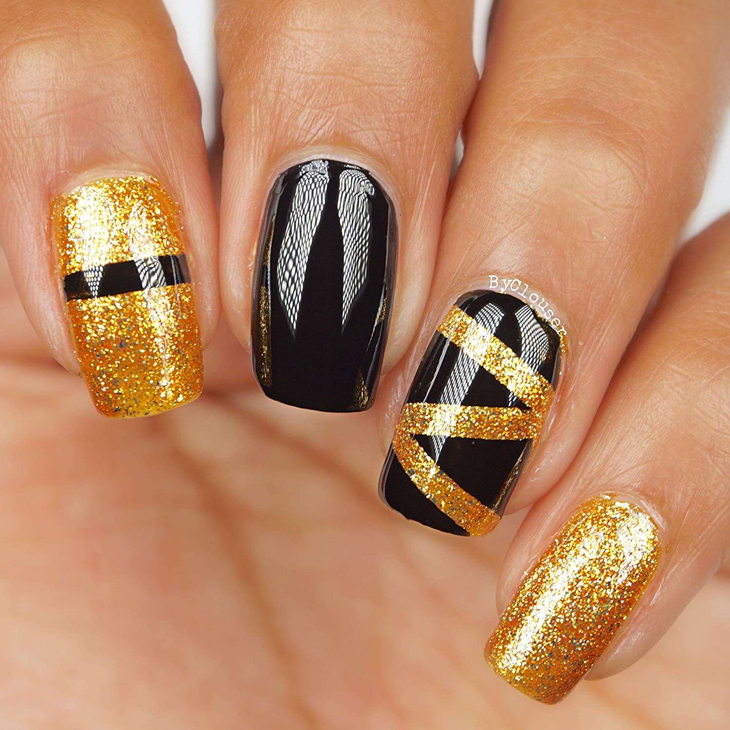 Premium Photo | A black and gold nail art design with gold and silver
